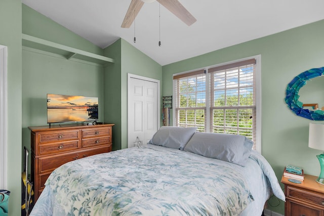 bedroom featuring vaulted ceiling, a closet, and a ceiling fan