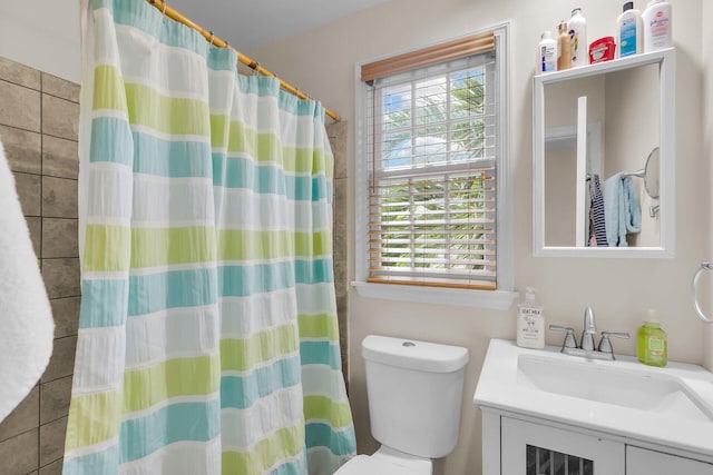 bathroom featuring vanity, toilet, and a shower with curtain