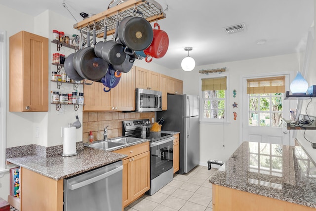 kitchen featuring light tile patterned floors, visible vents, decorative backsplash, appliances with stainless steel finishes, and a sink