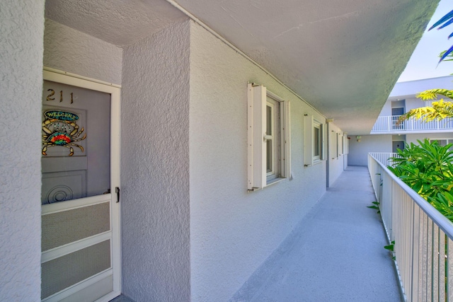 201 E Ocean Dr Unit 211, Key Colony, FL 33051 - doorway to property featuring stucco siding and a balcony