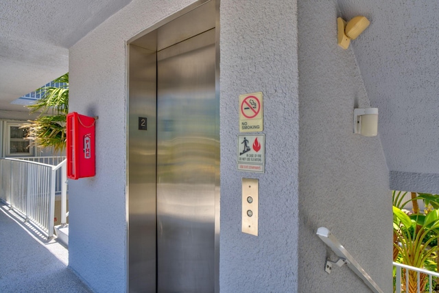 201 E Ocean Dr Unit 211, Key Colony, FL 33051 - elevator with stucco siding and a fire extinguisher