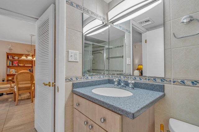 201 E Ocean Dr Unit 211, Key Colony, FL 33051 - bathroom with vanity, toilet, a stall shower, tile walls, and ornamental molding