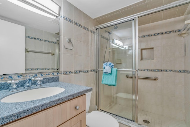 201 E Ocean Dr Unit 211, Key Colony, FL 33051 - bathroom featuring tile walls, a stall shower, toilet, and vanity