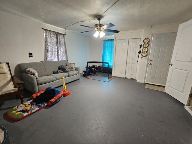 unfurnished living room with ceiling fan and a textured ceiling
