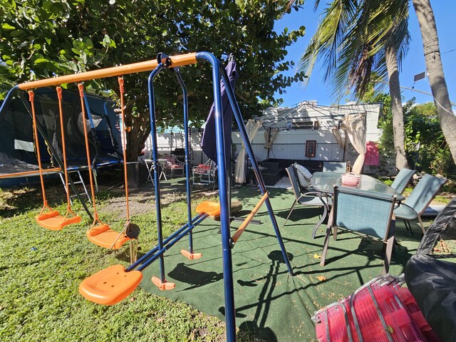 view of jungle gym with a trampoline
