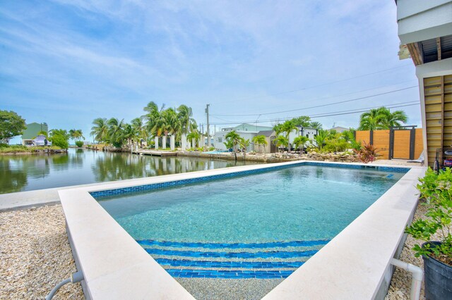 view of swimming pool with a water view