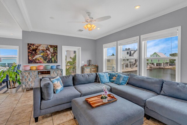 living room with crown molding, light tile patterned floors, and ceiling fan