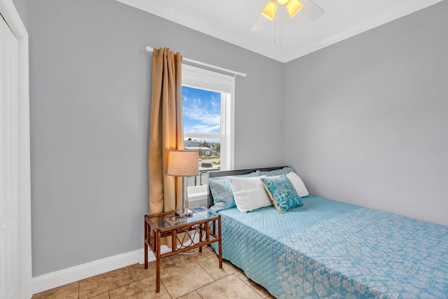 tiled bedroom with ornamental molding and ceiling fan