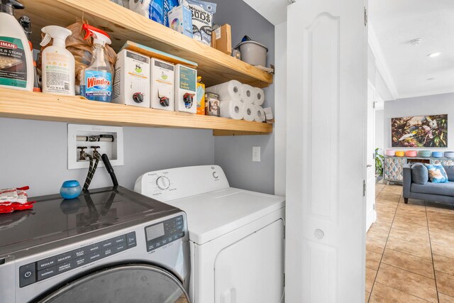 washroom featuring washing machine and dryer and light tile patterned floors