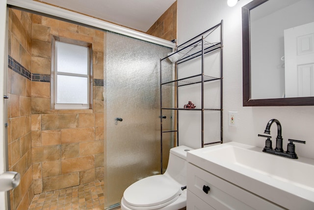 bathroom featuring vanity, tiled shower, and toilet