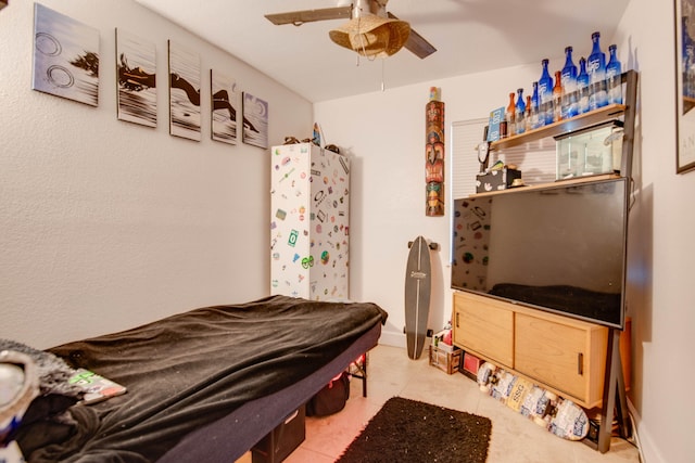 bedroom with ceiling fan, billiards, and light tile patterned floors