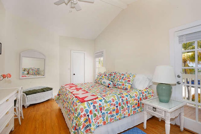 bedroom featuring hardwood / wood-style flooring, ceiling fan, and vaulted ceiling