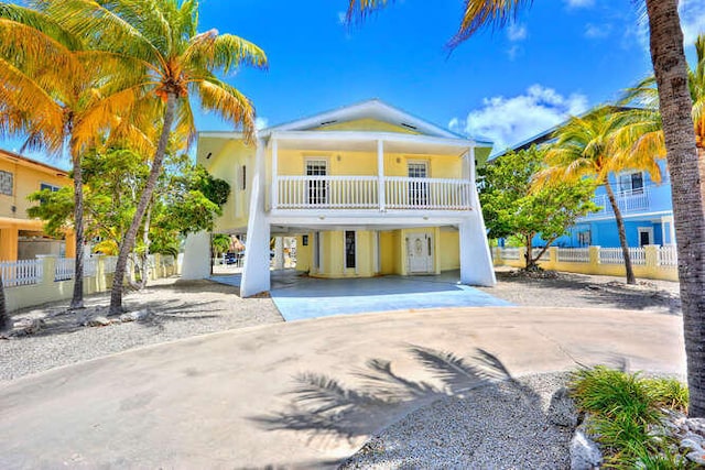 view of front facade with a balcony and a carport