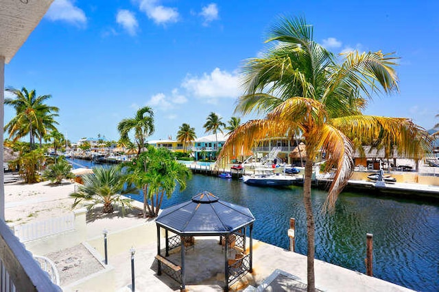 view of dock with a gazebo and a water view