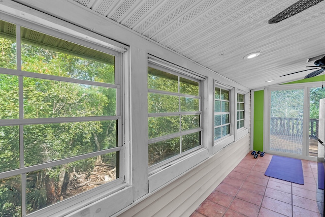 sunroom with ceiling fan and lofted ceiling