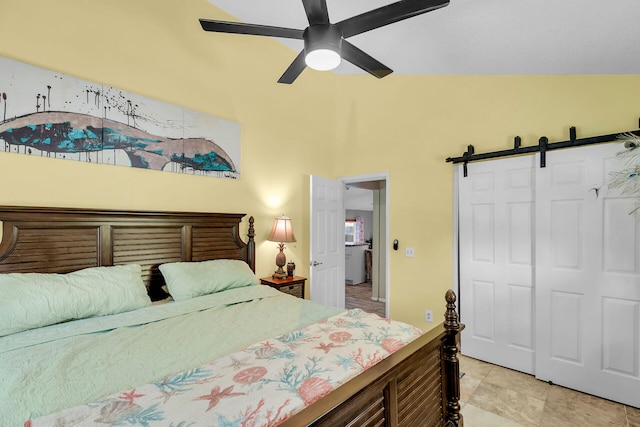 bedroom featuring a closet, a barn door, and ceiling fan