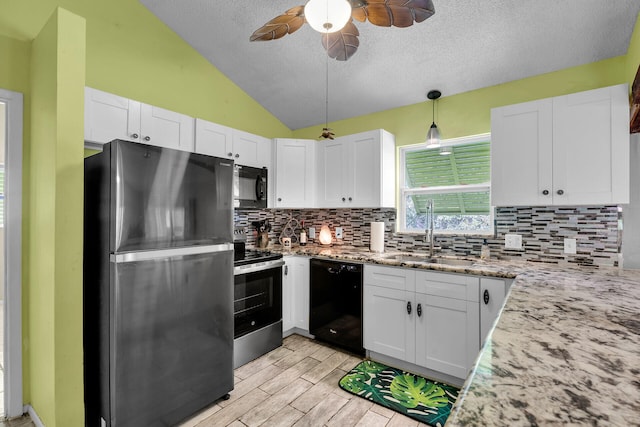 kitchen with white cabinetry, sink, decorative light fixtures, and black appliances