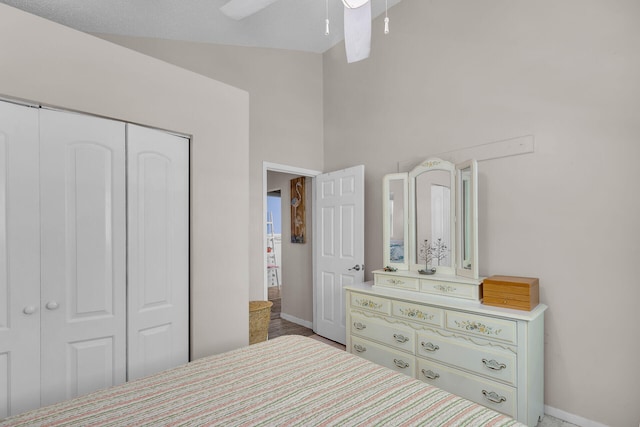 bedroom featuring high vaulted ceiling, a closet, and ceiling fan