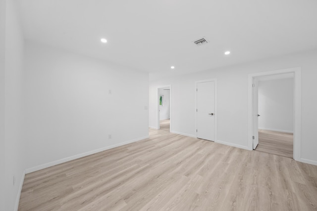 unfurnished bedroom featuring light wood-style flooring, baseboards, and recessed lighting
