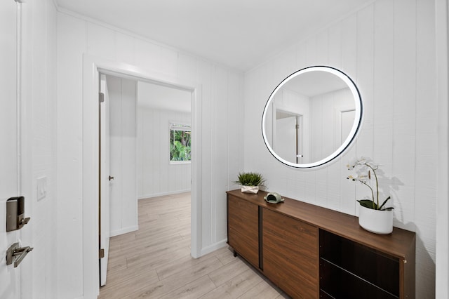 hall featuring light wood-type flooring and baseboards