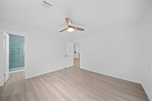 spare room with light wood-type flooring, baseboards, and ceiling fan