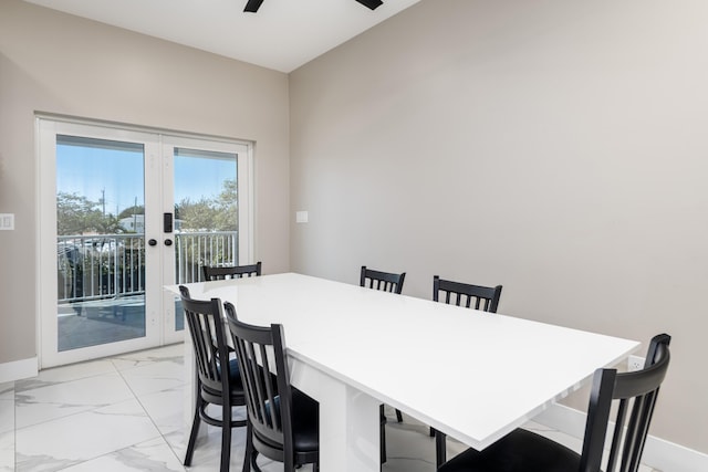 dining room featuring french doors, marble finish floor, baseboards, and a ceiling fan