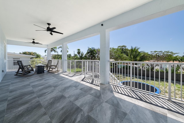 view of patio with fence and a ceiling fan