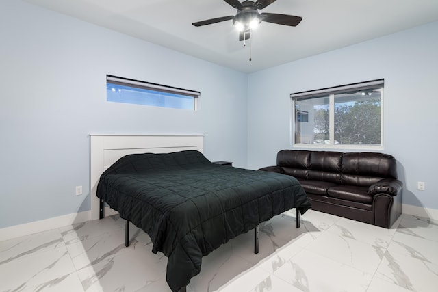 bedroom featuring baseboards, marble finish floor, and ceiling fan