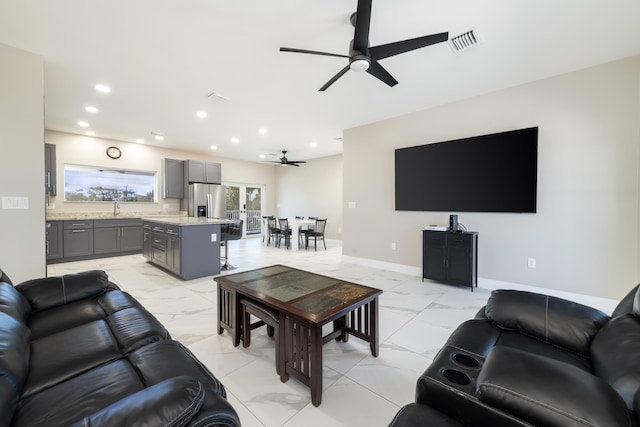 living room with baseboards, recessed lighting, a ceiling fan, visible vents, and marble finish floor