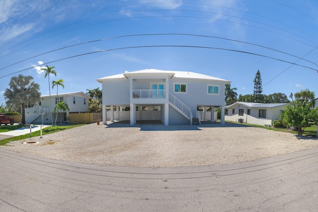 view of front of property with driveway, metal roof, and a carport