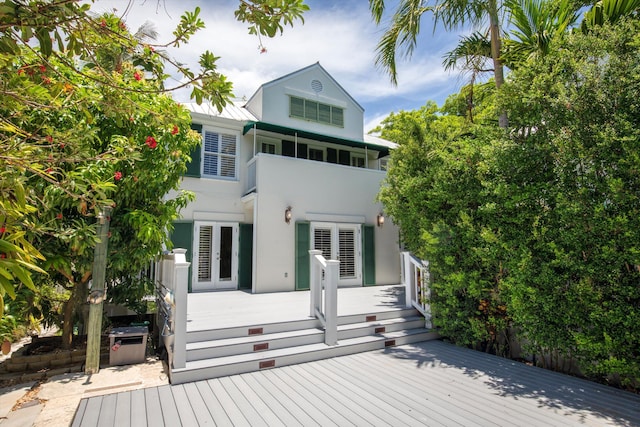 413 Emma St Unit A, Key West, FL 33040 - rear view of house with stucco siding, french doors, a deck, a balcony, and a metal roof