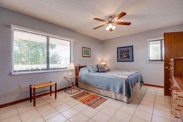 bedroom with light tile patterned flooring, ceiling fan, and multiple windows