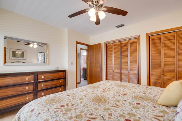 bedroom with two closets and ceiling fan