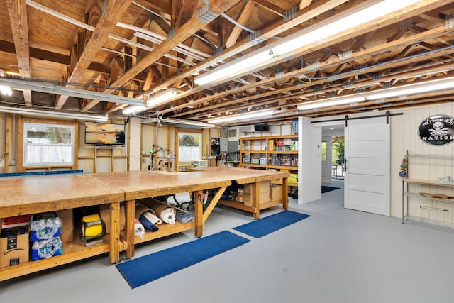 basement featuring a workshop area and a barn door