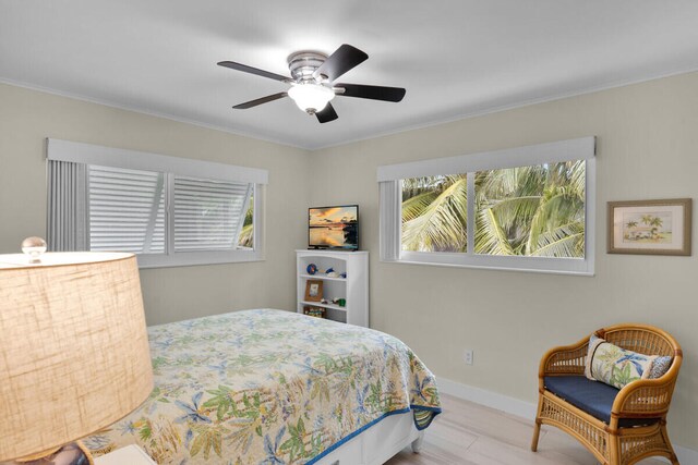 bedroom with ceiling fan and light hardwood / wood-style floors