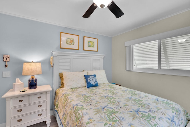 bedroom with hardwood / wood-style flooring, crown molding, and ceiling fan