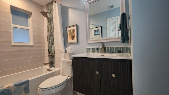 full bathroom featuring shower / bathtub combination with curtain, vanity, and toilet