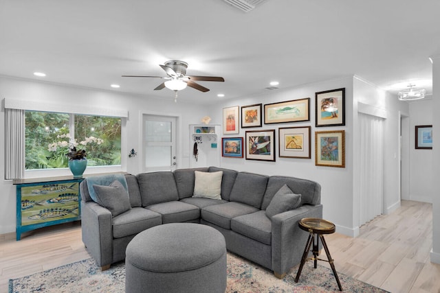 living room with ceiling fan and light wood-type flooring