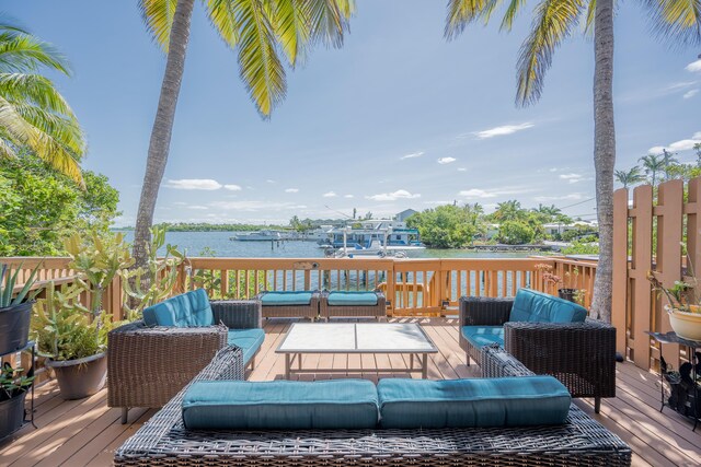 deck with a water view and an outdoor hangout area