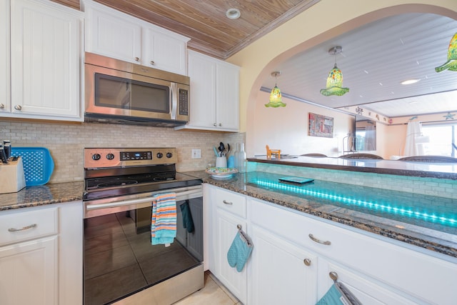 kitchen featuring appliances with stainless steel finishes, dark stone countertops, white cabinets, backsplash, and wooden ceiling