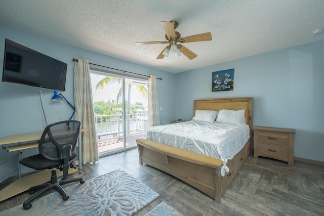 bedroom featuring ceiling fan, access to outside, and a textured ceiling