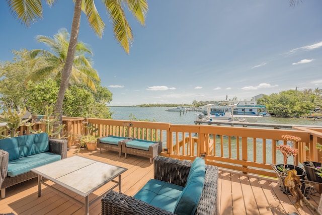 deck with a water view and an outdoor hangout area