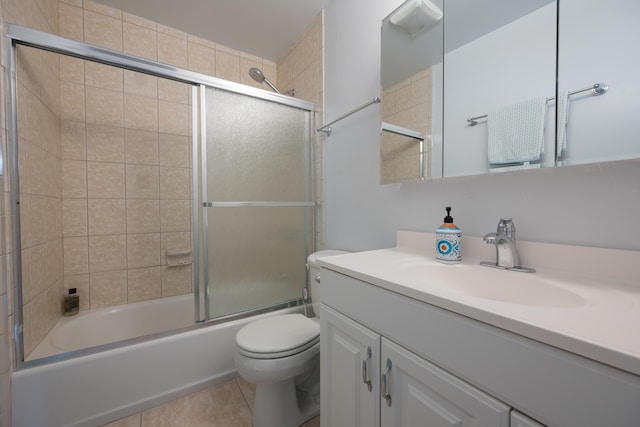 full bathroom featuring vanity, tile patterned floors, shower / bath combination with glass door, and toilet