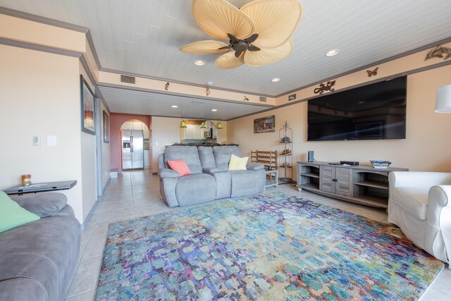 living room featuring ceiling fan and light tile patterned floors