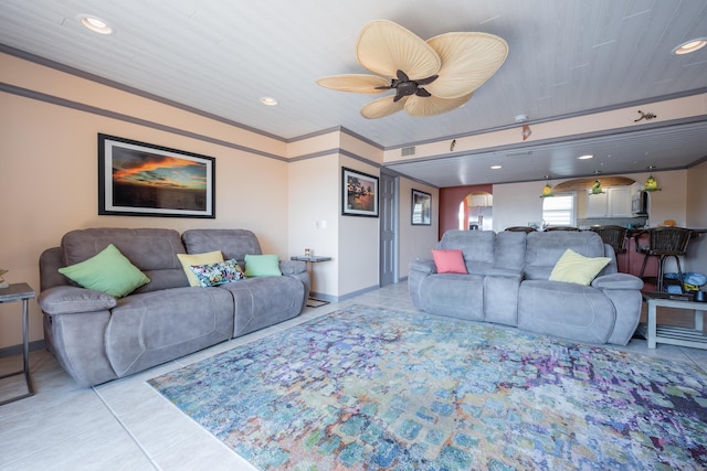 tiled living room featuring crown molding and ceiling fan