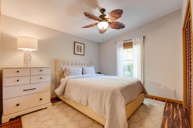 bedroom featuring vaulted ceiling, ceiling fan, and light wood-type flooring