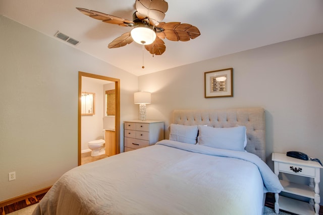 bedroom with vaulted ceiling, ensuite bathroom, and ceiling fan