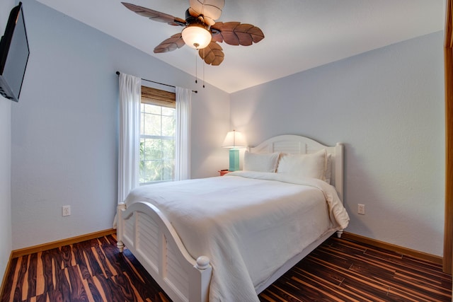 bedroom with lofted ceiling, dark hardwood / wood-style floors, and ceiling fan