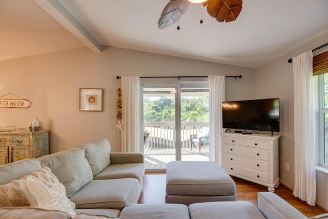 living room featuring hardwood / wood-style floors, lofted ceiling with beams, and ceiling fan