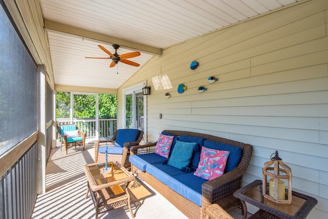 sunroom with lofted ceiling with beams and ceiling fan